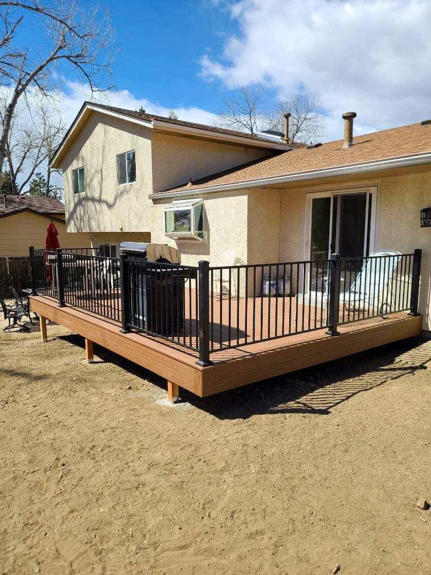 Custom deck with black metal railing built by All Custom Deck
